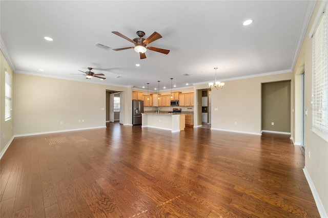 unfurnished living room with crown molding, ceiling fan with notable chandelier, and dark hardwood / wood-style floors