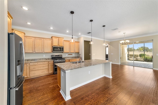 kitchen featuring sink, light stone counters, appliances with stainless steel finishes, pendant lighting, and a kitchen island with sink