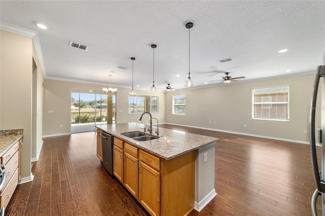 kitchen featuring sink, hanging light fixtures, dishwasher, an island with sink, and light stone countertops