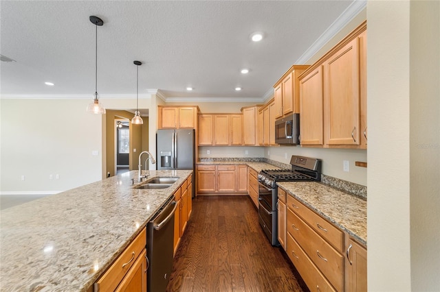 kitchen with sink, light stone counters, decorative light fixtures, dark hardwood / wood-style floors, and stainless steel appliances