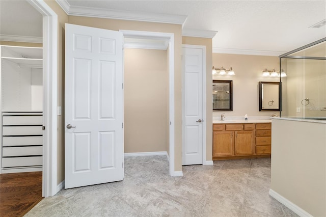 bathroom featuring ornamental molding and vanity