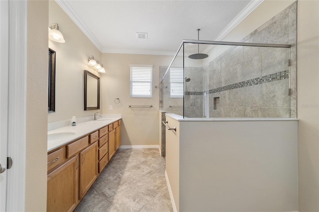 bathroom featuring ornamental molding, vanity, and a tile shower