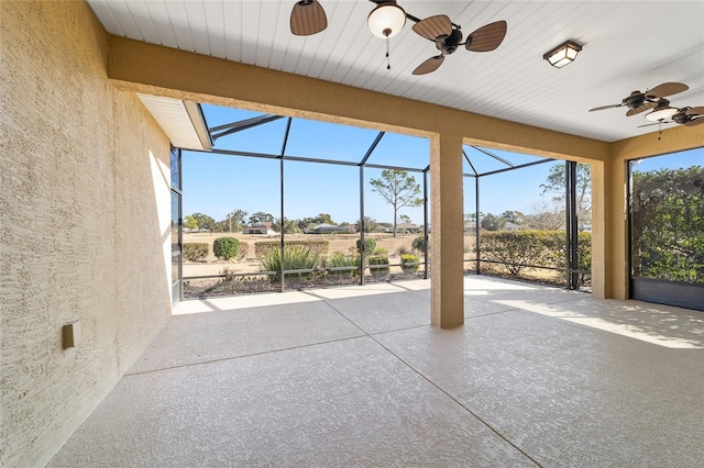 unfurnished sunroom with ceiling fan