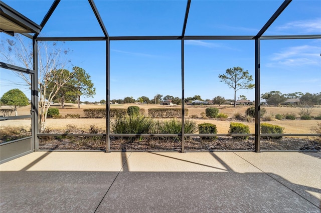 unfurnished sunroom with a rural view