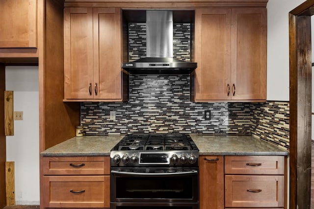 kitchen with decorative backsplash, gas stove, wall chimney exhaust hood, and stone counters