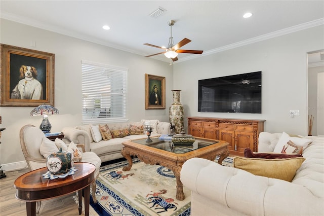 living room with ornamental molding, visible vents, and wood finished floors