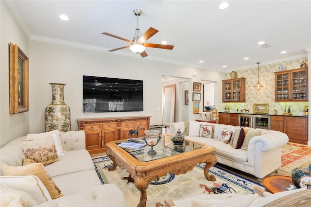 living area with wine cooler, visible vents, bar area, and ornamental molding