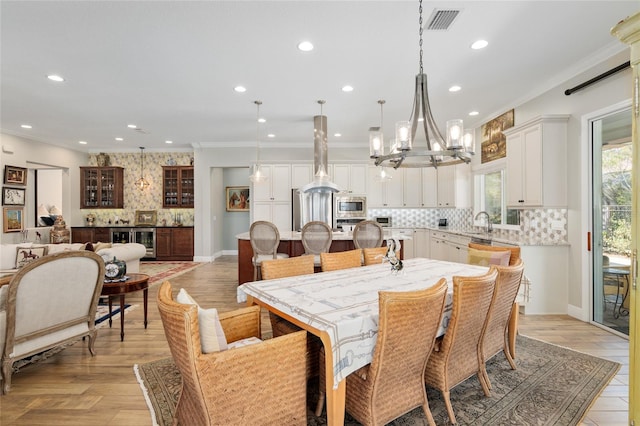 dining space with visible vents, crown molding, and recessed lighting