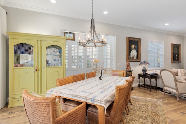 dining space with light wood finished floors, recessed lighting, ornamental molding, a chandelier, and baseboards