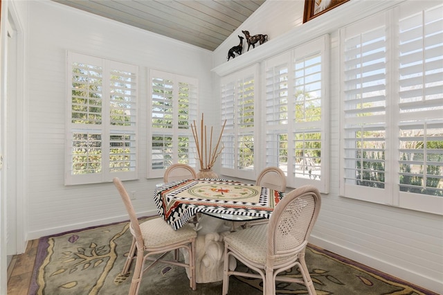 sunroom with a healthy amount of sunlight, wooden ceiling, and lofted ceiling