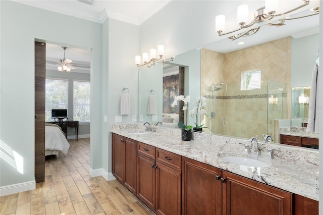 ensuite bathroom with ornamental molding, plenty of natural light, and a sink