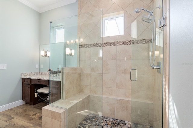 full bathroom with ornamental molding, a stall shower, a wealth of natural light, and vanity