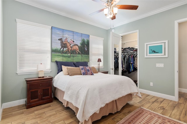 bedroom featuring light wood finished floors, baseboards, and ornamental molding