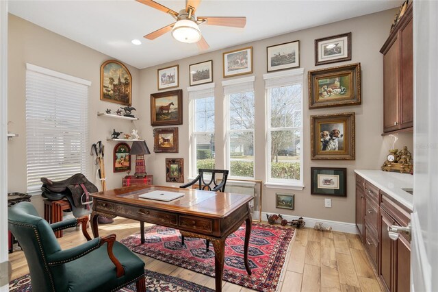 office space with ceiling fan, recessed lighting, light wood-style flooring, and baseboards