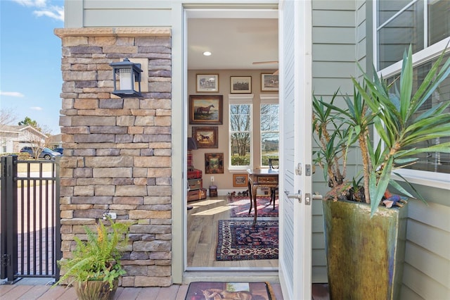 view of exterior entry featuring stone siding