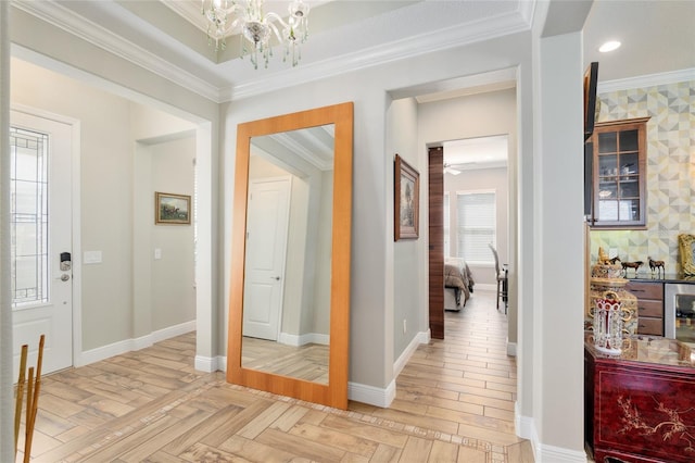 hall featuring baseboards, parquet floors, a notable chandelier, and crown molding