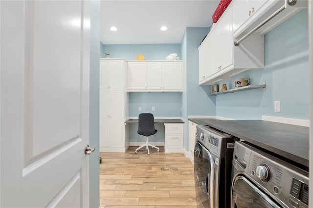 interior space featuring washing machine and dryer, light wood-style flooring, recessed lighting, baseboards, and cabinet space