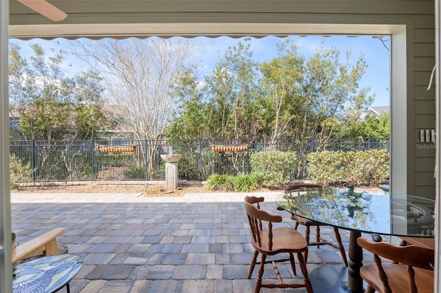 view of patio featuring outdoor dining space and fence