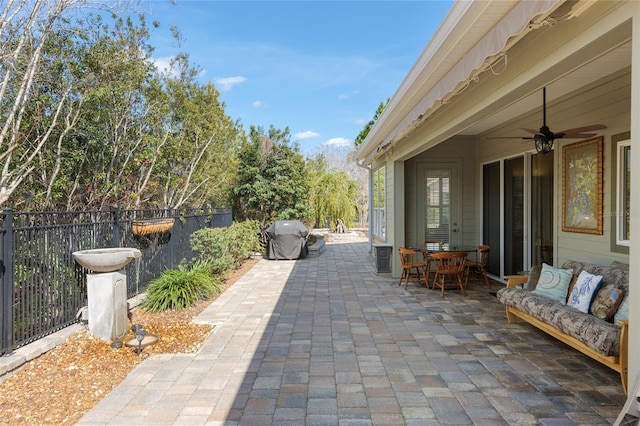 view of patio / terrace featuring ceiling fan, outdoor dining area, an outdoor hangout area, and fence