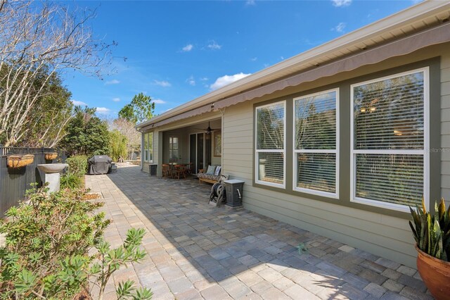 exterior space featuring a patio area, fence, and a ceiling fan