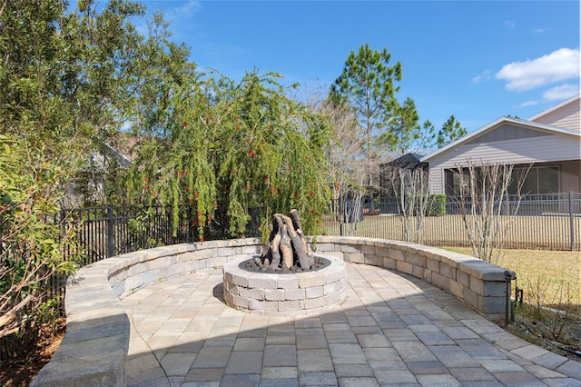 view of patio with fence private yard and a fire pit