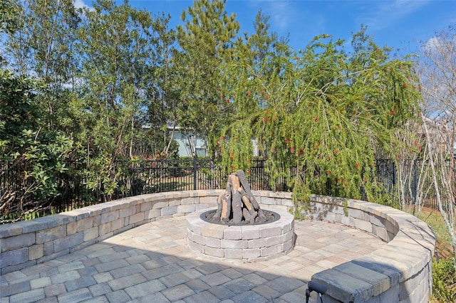 view of patio / terrace featuring an outdoor fire pit and fence