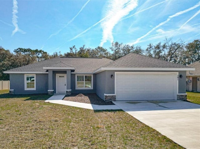 ranch-style home with a garage and a front lawn