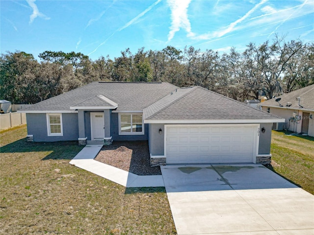 ranch-style home with a garage and a front yard