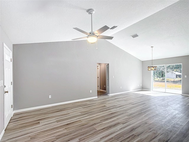 unfurnished living room with lofted ceiling, dark hardwood / wood-style floors, a textured ceiling, and ceiling fan