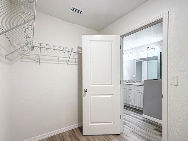 spacious closet with light wood-type flooring