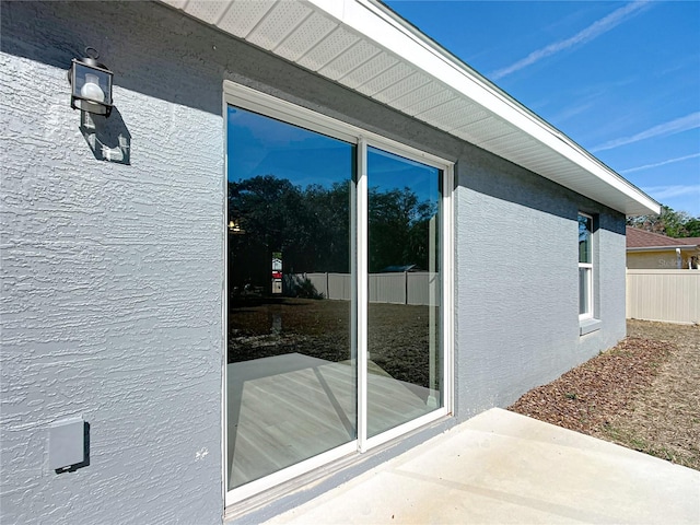 view of side of home with a patio