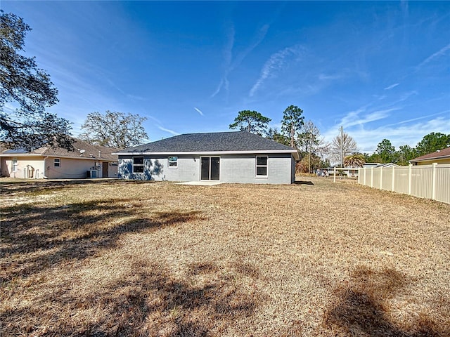 rear view of house with a lawn