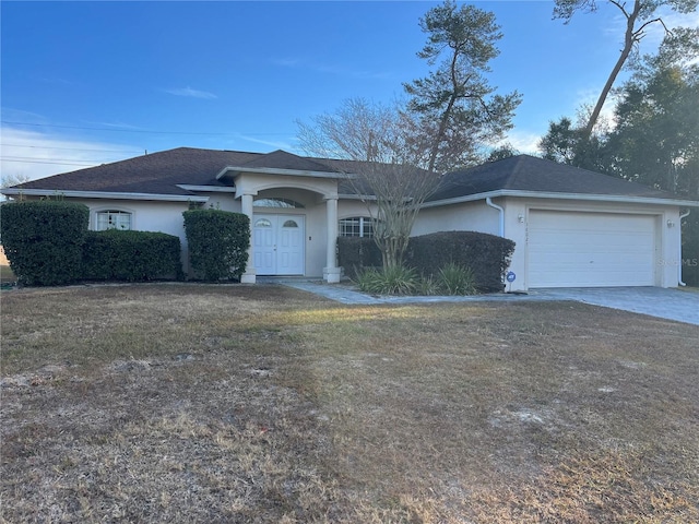 ranch-style home with a garage and a front lawn