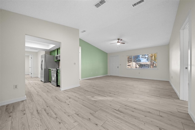 unfurnished living room with ceiling fan, light hardwood / wood-style floors, and a textured ceiling