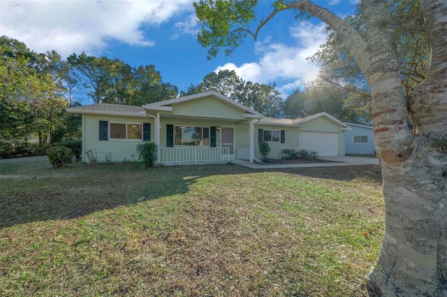 ranch-style home featuring a garage, a front yard, and covered porch