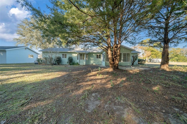 rear view of property featuring a yard