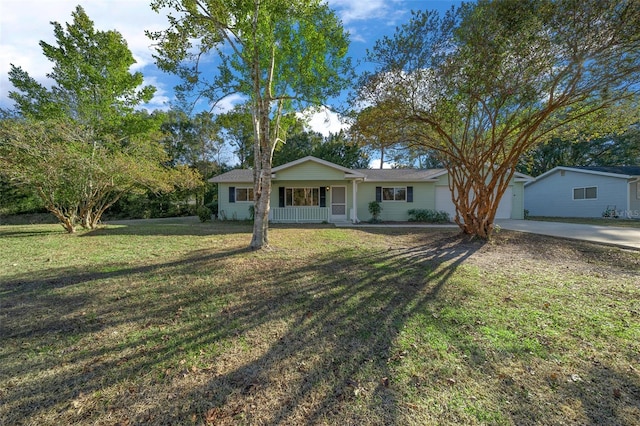 ranch-style house with a garage, a front yard, and covered porch