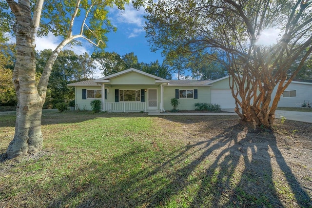 ranch-style home with a garage, covered porch, and a front lawn