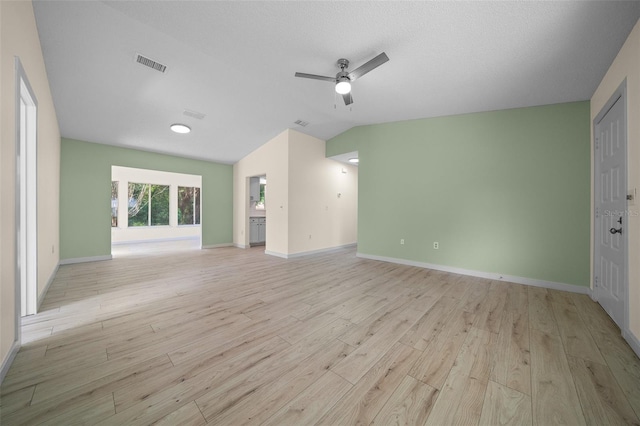 7556 SW 112th Ln, Ocala, FL 34476 - unfurnished living room featuring light wood-style floors, a ceiling fan, baseboards, and vaulted ceiling
