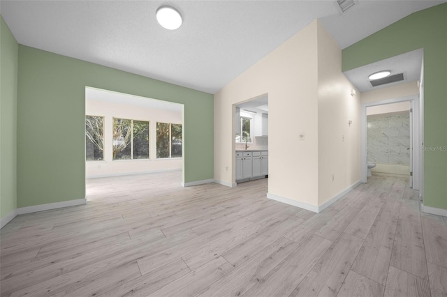 7556 SW 112th Ln, Ocala, FL 34476 - spare room with light wood-style floors, baseboards, and lofted ceiling