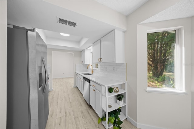7556 SW 112th Ln, Ocala, FL 34476 - kitchen featuring a sink, a healthy amount of sunlight, visible vents, a raised ceiling, and appliances with stainless steel finishes