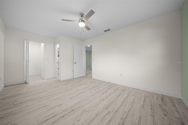 7556 SW 112th Ln, Ocala, FL 34476 - spare room featuring a ceiling fan, light wood-style floors, visible vents, and baseboards