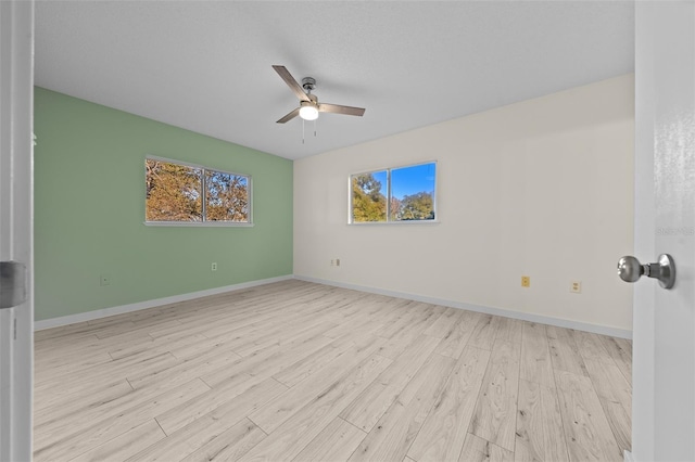 7556 SW 112th Ln, Ocala, FL 34476 - spare room featuring a wealth of natural light, baseboards, wood finished floors, and a ceiling fan