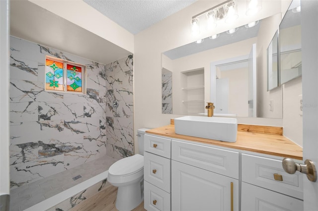 7556 SW 112th Ln, Ocala, FL 34476 - full bath featuring a shower stall, vanity, toilet, and a textured ceiling