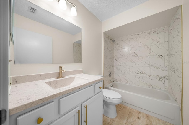 7556 SW 112th Ln, Ocala, FL 34476 - full bathroom featuring toilet, vanity, bathing tub / shower combination, wood finished floors, and a textured ceiling