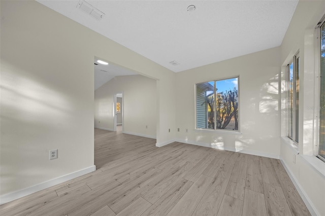 7556 SW 112th Ln, Ocala, FL 34476 - spare room featuring light wood finished floors, baseboards, and lofted ceiling