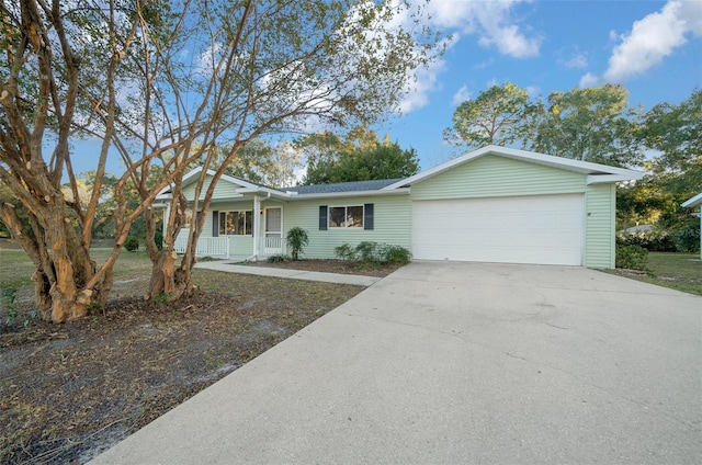 7556 SW 112th Ln, Ocala, FL 34476 - ranch-style house with a garage, driveway, and covered porch