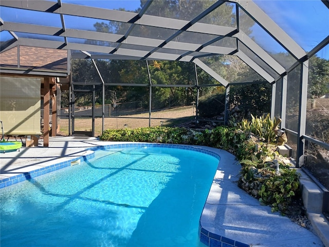 pool featuring glass enclosure and a patio