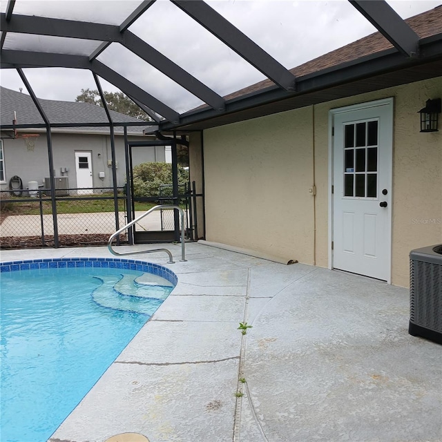 outdoor pool featuring a lanai, a patio, and central air condition unit