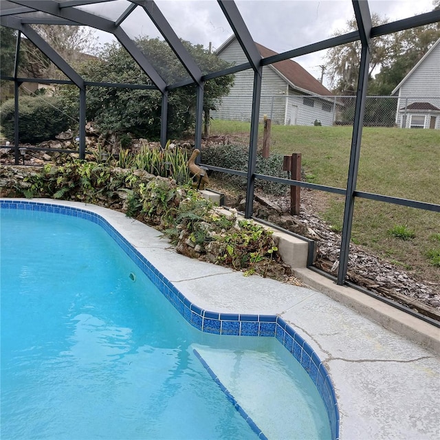 pool with glass enclosure and a yard